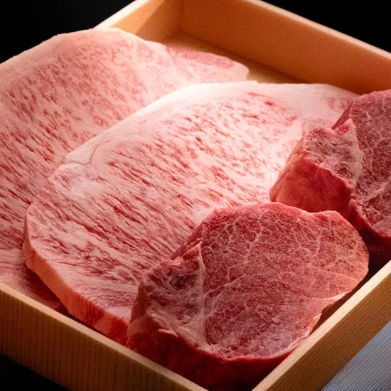 Raw Miyazakigyu cuts with dense marbling, presented in a wooden box